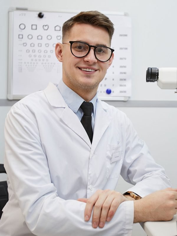 male-optometrist-smiling-at-camera-2021-04-06-16-28-38-utc.jpg